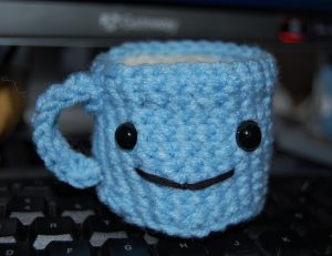 Crocheted blue mug with smiley face